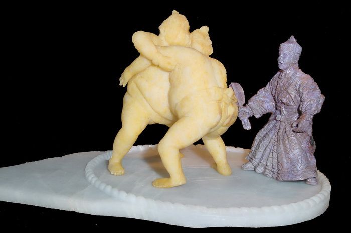 Orthodox Japanese Sumo Wrestlers Battling Each Other, While Referee Supervises